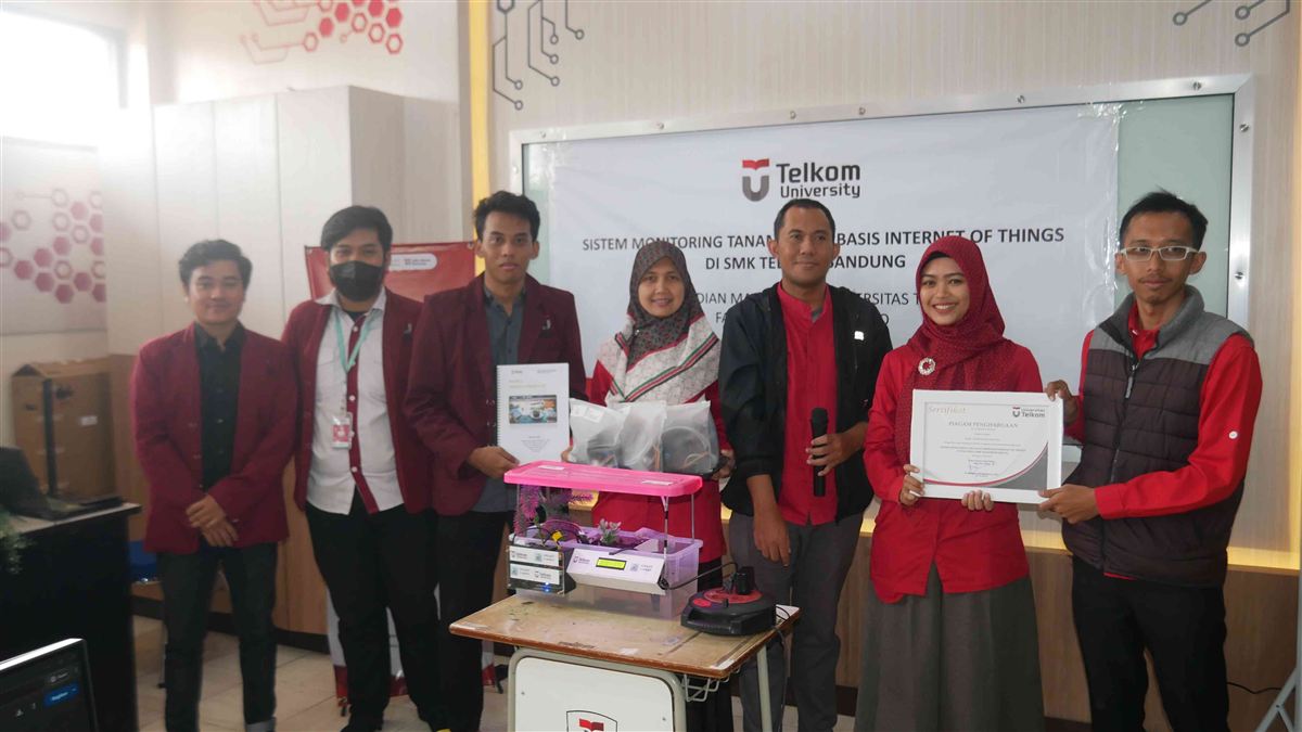Tim Telkom University memperlihatkan perangkat Smart Garden dan piagam penghargaan di SMK Telkom Bandung